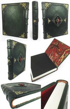 an assortment of leather bound books with designs on them