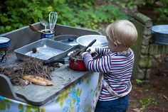 a little boy that is standing in front of a sink