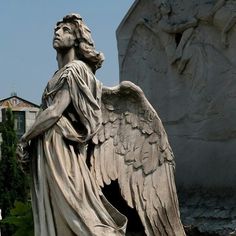 an angel statue in front of a building