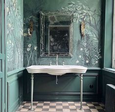 a bathroom with a checkered floor and green walls