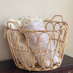 a basket that has some pillows in it