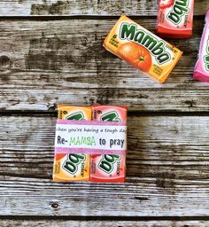 three candy bars sitting next to each other on top of a wooden table with the words momo written on them