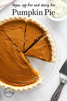 a pumpkin pie on a white plate with a slice cut out and the words vegan, gf free and dairy free