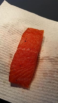 a piece of raw salmon on a napkin