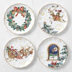 four plates decorated with christmas scenes on them