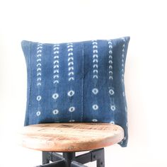 a blue pillow sitting on top of a wooden chair