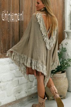 Cotton Open Back Poncho is a very original designer garment to compliment your boho outfit on a cool summer evening. High cotton canvas collar is reminiscent of elegant XIX century lady cloak, while long gorgeous linen fringe on the hemline brings an ultimate boho touch to the piece. The back of the poncho is open and also decorated with the statement fringes of our Alma Libra collection. It is made of 100% natural raw and very soft cotton. In hot climate you can wear this Poncho with our open b Bohemian Beige Long Sleeve Cover-up, Bohemian Long Sleeve Fringe Cover-up, Bohemian Brown Cover-up For Summer, Bohemian Brown Cover-up For Spring, Bohemian Brown Summer Cover-up, Bohemian V-neck Poncho For Vacation, Bohemian Beige Poncho For Vacation, Bohemian Brown Poncho For Festivals, Brown Bohemian Poncho For Festivals