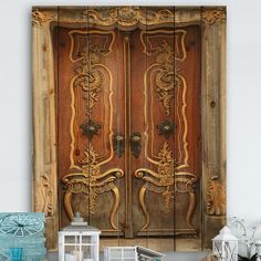 an old wooden door with ornate carvings on the front and side panels is displayed against a white wall