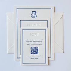 the wedding stationery is laid out on top of each other, with an anchor in the middle