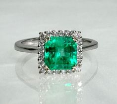 Square cut ring, emerald ring, emerald engagement ring, emerald ring for women, emerald diamond ring, 18k Emerald ring, 18K white gold ring A gorgeous emerald ring featuring a square step cut center stone weighing 1.24 carats surrounded by sparkling colorless diamonds set in solid 14k white gold. *Ring size: US 7 3/4 *Ring weight: 3.15 Grams *Center stone dimensions: 6.5mm Square Cut Ring, Square Cut Rings, Engagement Ring Emerald, Emerald Diamond Ring, Colorless Diamond, Ring Emerald, Etsy Gold Ring, Step Cut, Emerald Engagement