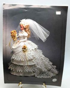 a barbie doll dressed in a white wedding dress and veil with sunflowers on it