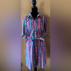 Preppy Classic Tommy Hilfiger Shirt Dress With Belt And Sleeves That Can Be Rolled To 3/4 . P2p- 18.5” -Color Is Rainbow Multi Colored Plaid With A Reversible Floral Hem And Reversible Belt -100% Cotton -Two Side And Two Chest Pockets -Machine Washable -Point Collar. Button-Front Closure -Belt Ties At Waist -On-Seam Pockets -Unlined -Rounded Hem -Hits At Thigh Just Above The Knee -Never Worn -Rounded Hem *Smoke Free Home* Pink Cotton Shirt Dress For Day Out, Long Sleeve Pink Cotton Shirt Dress, Pink Long Sleeve Cotton Shirt Dress, Pink Collared Shirt Dress For Daywear, Multicolor Button-up Shirt Dress For Work, Fitted Multicolor Shirt Dress With Buttons, Collared Pink Shirt Dress For Workwear, Pink Button Closure Shirt Dress For Work, Casual Pink Cotton Shirt Dress