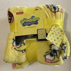 the spongebob pajamas are yellow and have cartoon faces on them, along with a tag