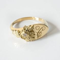 This vintage-inspired floral ring is a row of dainty flowers wrapped around your fingers. Handmade and polished, it is available in solid 8K and 14K gold. This item is engravable with text or monogram of your choice at no extra cost. The initals are engraved onto the ring and embedded in the 3D model for a flawless embossed finish. It is also possible to add a diamond or birthstone or diamond to this ring at an additional fee. Please inquire for details. A few notes about our gold:- Though we do Ladies Signet Ring, Vintage 14k Gold Flower Ring With Rose Cut Diamonds, Heirloom 14k Gold Flower Ring With Rose Cut Diamonds, Vintage Flower Shaped Jewelry With Rose Cut Diamonds, Classic Flower Shaped Diamond Ring For Anniversary, Yellow Gold Flower Ring With 17 Jewels For Anniversary, Vintage Flower Shaped Diamond Ring, Heirloom 14k Gold Flower Ring, Heirloom Style 14k Gold Flower Ring