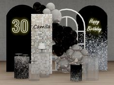 an assortment of black and white birthday decorations