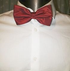 Claret red silk bow tie by Austin Reed. Adjustable length. Dapper Red Suit And Tie Accessories For Formal Events, Red Satin Bow Tie Adjustable, Dapper Red Suit And Tie Accessories For Formal Occasions, Elegant Red Bow With Butterfly Knot, Adjustable Red Satin Bow Tie, Red Butterfly Knot Bow Tie For Black Tie Events, Red Bow Tie For Party, Red Bow Standard Bow Tie For Party, Red Satin Standard Bow Tie