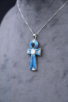 a blue ribbon cross necklace on a mannequin