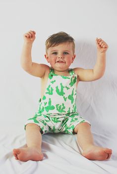 This overall romper is the perfect outfit - great in warmer weather on it's own or in cooler weather layered over a shirt. We make this one out of awesomely soft organic cotton knit with a modern cactus print on it and include gold snaps for the fasteners. It is partially lined on the top. Diaper changes are so easy - just unsnap two snaps and pull the whole thing down. Much easier than snaps at the inseam on a squirmy baby! F A B R I C This romper features 100% organic cotton knit fabric produc Casual Fitted Bubble Romper For Loungewear, Fitted Cotton Bubble Romper For Loungewear, Green Fitted Casual Onesie, Green Cotton Jumpsuit For Loungewear, Green Cotton Jumpsuits And Rompers For Loungewear, Cotton Overalls For Playtime In Spring, Spring Cotton Overalls For Playtime, Green Cotton Onesie For Spring, Casual Printed Bubble Romper For Play