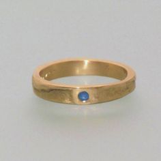 This ring is our popular 4 mm, 14 kt yellow gold casting ring. However, this particular ring features a 1.0.31 inch, 8 mm sapphire gemstone. Upon request, the ring can also be crafted with rose-colored or white gold. The shown price refers to a ring with a size of 48. Different prices can be shown by selecting the appropriate ring size. For example, a pair of rings with sizes of 52 and 59 would cost around For men, the ring can be ordered without the gemstone. You can also choose to include a na Gold Sapphire Birthstone Ring For Promise, Gold Sapphire Ring With Bezel Setting And Round Band, Gold Sapphire Stackable Promise Rings, Gold Sapphire Stackable Rings For Promise, Gold Sapphire Birthstone Ring, Gold Sapphire Birthstone Ring With Round Band, Classic Gold Stackable Sapphire Rings, Classic Gold Sapphire Stackable Rings, Yellow Gold Sapphire Ring With Tension Setting