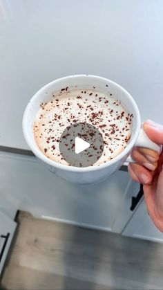 a person holding a cup of hot chocolate