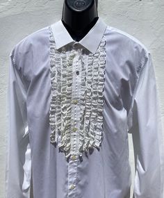 "Authentic Vintage Spanish Shirt from Andalucia in Southern Spain Typical Style Equestrian Horse Riding/Flamenco Formal Dress Shirt XLSize Chest 50\"(126cm).   P to pit 25\"(63.5cm) Sh to sh 20\"(50.5cm).   Collar 18\"(45.5cm).   Length from Nape to hem 31\"(78.5cm) Sleeves fro Sh to cuff 27\"(68.5cm).  P to cuff 21\"(53.5cm) PLEASE CHECK ALL THE MEASUREMENTS OR IT MIGHT NOT FIT!! Good Quality White Cotton Shirt with Nylon Lace Machine washable  Very Good Vintage Condition  4 bands of Lace Frills either side of the button band 2 Sparkling Rhinestone Buttons in Silver Tone Metal Clasps All the others are regular white shirt buttons  Frilled Cuffs Ref: FB9/SH4 Shipping  I usually send with Economy International Post  Delivery time 2-3 weeks approx depending on destination" Fitted Ruffle Shirt Elegant Style, Designer Fitted White Shirt, Fitted White Shirt With Ruffles, Fitted Shirt For Party, Formal White Ruffled Shirt, White Ruffled Shirt For Formal Occasions, Formal Shirt With Ruffles, Designer Fitted Shirt For Summer, Designer Fitted Tops With Ruffles