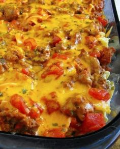 a casserole dish with meat, cheese and tomatoes in it is ready to be eaten