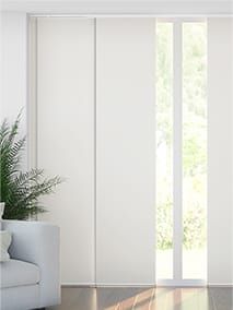 a living room with white furniture and sliding glass doors