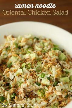 a white bowl filled with chicken salad on top of a wooden table