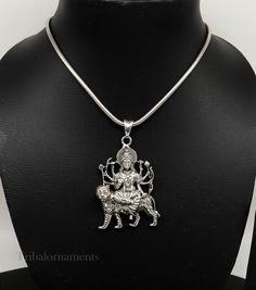 Divine 92.5 sterling silver Indian Hindu Idols Blessing Goddess Bhawani/Durga/Santoshi maa with lion vintage antique style stunning divine pendant, best gifting unisex jewelry from India. Metal-925 sterling silver. Item type-Pendant/ Locket Weight-17.910 grams. Height-5.9 centimeter. Width-3.5 centimeters. Stamped-925. Finish-Oxidized. note :chain is not include in this price, to purchase chain please visit following links: https://www.etsy.com/listing/823425858/16-to-30-long-screw-chain-925-ste Sterling Silver Jewelry For Navratri Festival, Sterling Silver Pendant Necklace For Diwali, Sterling Silver Jewelry For Diwali, Traditional Silver Jewelry For Navratri, Silver Round Pendant Necklace For Diwali, Silver Jewelry For Festivals, Sterling Silver Necklace For Puja And Festivals, Sterling Silver Necklace For Puja And Diwali, Sterling Silver Jewelry For Puja And Festivals