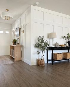 a living room with wood floors and white walls