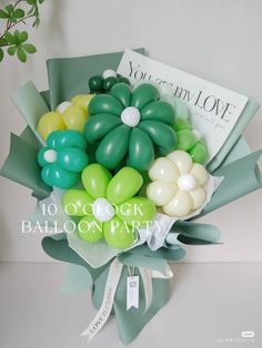 a bouquet of balloons in green, white and yellow