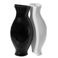 two black and white vases sitting side by side