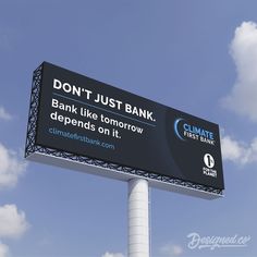 a large billboard on top of a white pole in front of a cloudy blue sky