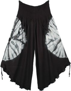 A cropped wide-leg pant. features smocked elastic waistband, 2 front tie pockets, and tie ruffle leg opening. A chic pair of wide-leg culotte pants in black with a white tie-dye that goes around the middle of the pants, back, and front. This style is totally fresh and you will be ahead of fashion. The front pockets come with a functional tie-up string that gives it a boho look. Similar functional tie-ups are attached at the bottom of these pants and can be pulled to make the leg opening higher. Bohemian Drawstring Trousers, Bohemian Wide-leg Pants With Drawstring, Bohemian Wide-leg Drawstring Pants, Summer Harem Pants With Drawstring, Black Drawstring Wide Leg Pants For Summer, Bohemian Tie-waist Bottoms, Bohemian Long Pants With Tie Waist, Summer Parachute Pants With Drawstring, Spring Pants With Drawstring And Tie-side Bottom