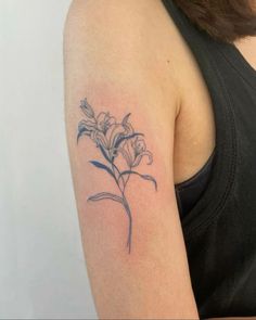 a woman with a flower tattoo on her arm