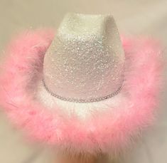 a white hat with pink fur around the brim