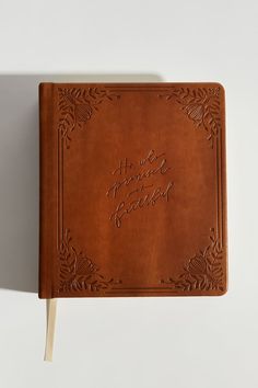 a brown leather book with writing on it