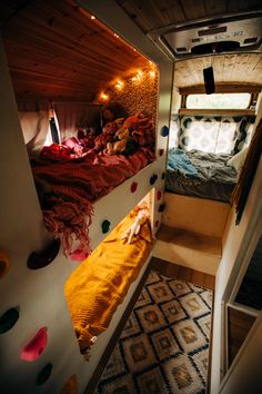 the interior of a camper with bunk beds and lights