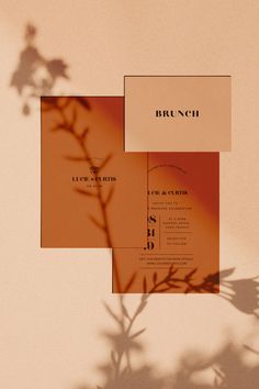 an orange and white wedding card with the word brunch in black on it