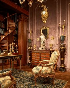 an ornately decorated living room with antique furniture