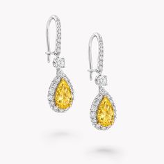 Displaying a vivid, beautifully saturated hue, two pear shape Fancy Yellow diamonds radiate joy and happiness at the heart of our Icon earrings in white and yellow gold. Suspended from graceful pavé clips, each earring is complemented by a gleaming halo of pavé white diamonds, expertly set to scintillate from every angle. With a legacy of cutting and polishing many of the world’s most fabulous yellow stones, Graff has an enduring affinity for yellow diamonds, which have become synonymous with the House. Model wears a vibrant and vivacious pair of Icon pear shape yellow and pavé white diamond earrings with a total weight of 3.41 carats, showcasing two certified Fancy Yellow pear shape diamonds weighing more than 1.00 carats each. Diamond Shaped Engagement Ring, White Diamond Earrings, Yellow Diamonds, Fancy Yellow Diamond, Engagement Ring Shapes, Bridal Engagement Rings, Yellow Stone, Stacked Jewelry, Pear Shaped Diamond