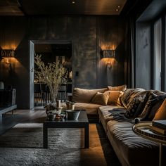 a living room filled with lots of furniture next to a large glass window covered wall