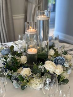 a table with candles and flowers on it