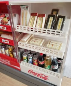 a refrigerator filled with lots of different types of drinks and condiments on shelves