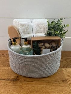 a basket filled with lots of items on top of a wooden floor