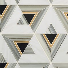 an artistic tile design with black, white and gold triangles in the center is shown