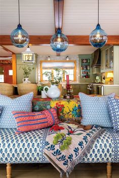 a living room filled with lots of colorful pillows