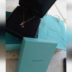 Authentic Tiffany & Co. Peretti 18k Gold Initial Letter "B" Pendant Necklace 16". Alphabet Accessory Brand Tiffany & Co. 100% Authentic 18 K Rose Gold Size About Chain 41 Cm Top 1 X 2.6 Cm Material 18k Accessories Preservation Box, Blue Tiffany & Co Box And Gift Bag. The Blue Box Is In Pretty Good Condition But The Gift Bag Has Some Stains, Ripped And Shows Signs Of Handling. Please See Pictures. Letter Necklace Gold Tiffany & Co., Letter Pendant Necklace Tiffany & Co., Designer Yellow Gold Evening Necklace, Designer Yellow Gold Necklaces For Evening, Designer Yellow Gold Necklace For Evening, Designer Gold Necklaces For Anniversary, Designer Yellow Gold Necklace For Wedding, Designer Yellow Gold Necklace For Anniversary, Luxury 14k Stamped Initial Pendant Necklace