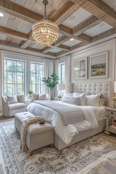 a large bed sitting under a chandelier in a bedroom next to a window