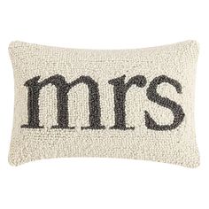 an embroidered pillow with the word mrs in black and white letters on it's side